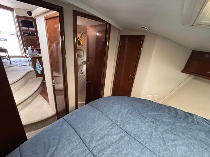 Slide: The Image of Interior of 2007 Carver 35 Super Sport yacht with cozy bedroom and wooden cabinetry. - 25