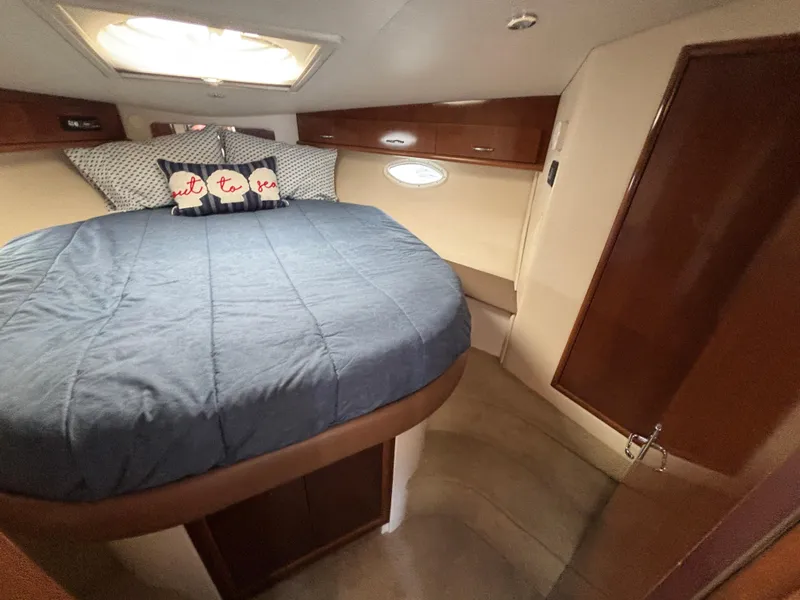 Slide: The Image of 2007 Carver 35 Super Sport cabin with cozy bed and nautical decor. - 26