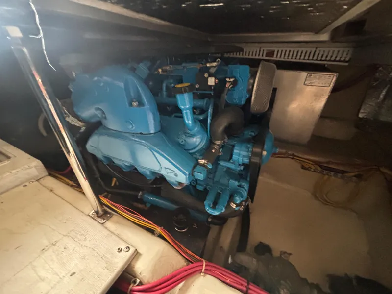 Slide: The Image of Engine compartment of a 2007 Carver 35 Super Sport boat, featuring a blue engine. - 3