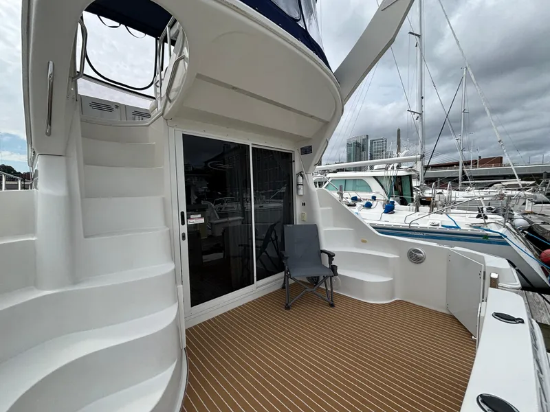 Slide: The Image of 2007 Carver 35 Super Sport yacht deck with stairs and marina view. - 5