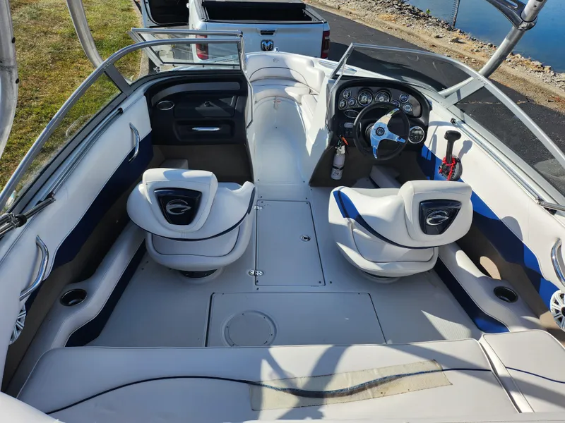 Slide: The Image of 2012 Crownline 195 SS boat interior with white seating and dashboard controls. - 10