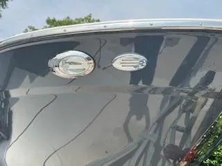 Slide: The Image of 2023 Solara S-250 DC boat hull with chrome fixtures and reflections. - 10