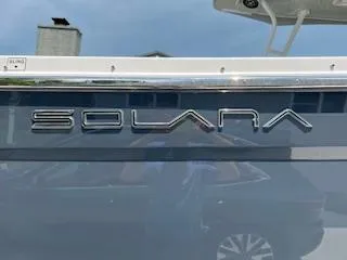 Slide: The Image of 2023 Solara S-250 DC boat logo on sleek blue surface. - 11