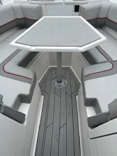 Slide: The Image of 2023 Solara S-250 DC boat interior with sleek seating and central table. - 17