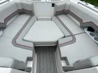 Slide: The Image of 2023 Solara S-250 DC boat interior with gray seating and red accents. - 18