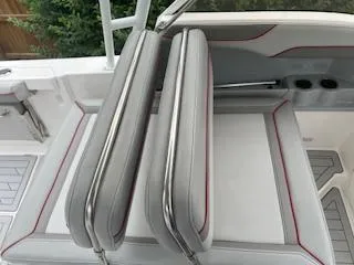 Slide: The Image of 2023 Solara S-250 DC boat seating with gray cushions and red accents. - 22
