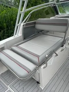 Slide: The Image of 2023 Solara S-250 DC boat with gray cushioned seating and sleek design. - 24