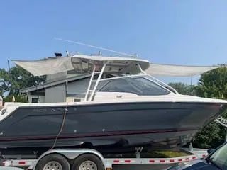 Slide: The Image of 2023 Solara S-250 DC boat on trailer, side view, under clear blue sky. - 3