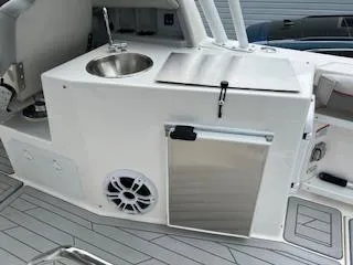 Slide: The Image of 2023 Solara S-250 DC boat interior with sink, storage, and speaker. - 38