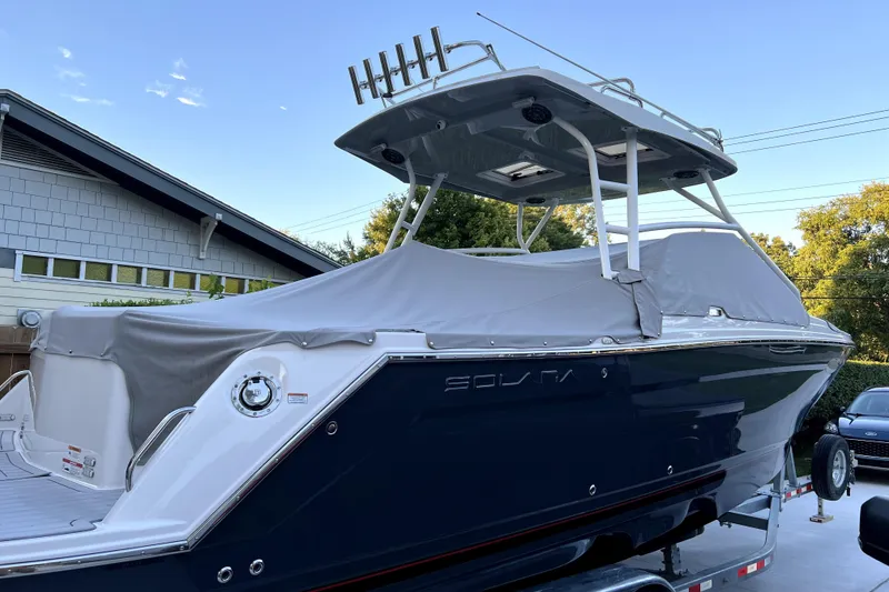Slide: The Image of 2023 Solara S-250 DC boat with cover, parked on trailer, side view. - 6