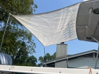 Slide: The Image of 2023 Solara S-250 DC boat with a white sunshade, set against a clear blue sky. - 8