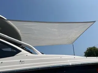 Slide: The Image of 2023 Solara S-250 DC boat with sunshade against clear blue sky. - 9