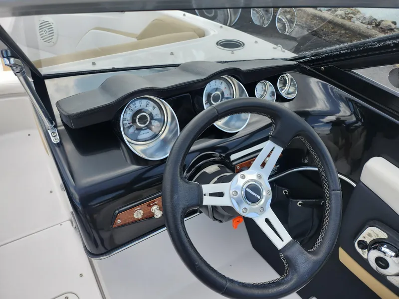 Slide: The Image of 2016 Glastron GT 205 boat dashboard with steering wheel and gauges. - 16