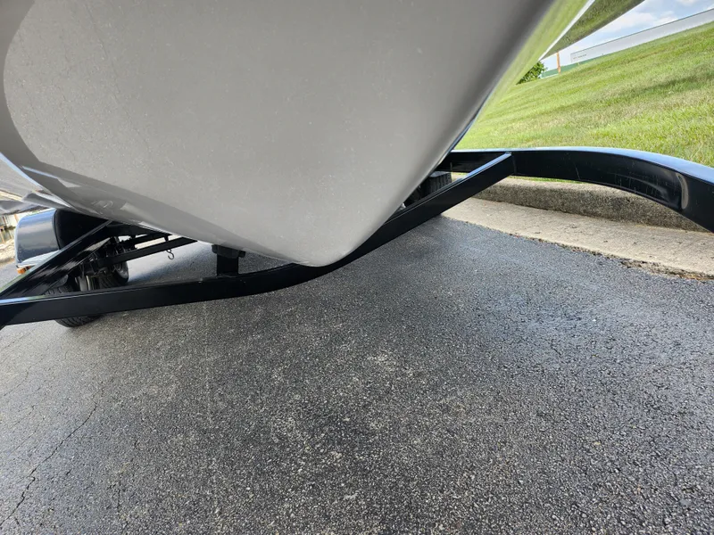 Slide: The Image of 2016 Glastron GT 205 boat on trailer, close-up view of hull and pavement. - 8