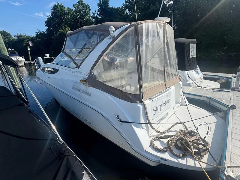 Slide: The Image of 2001 Bayliner 2855 Ciera boat docked, featuring a covered cockpit and sleek design. - 1