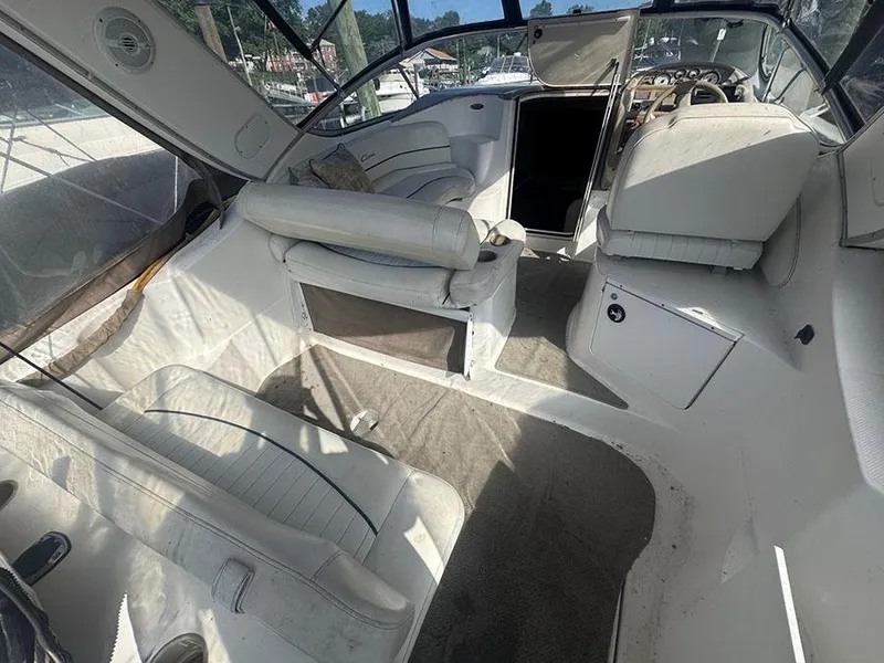Slide: The Image of 2001 Bayliner 2855 Ciera boat interior with white seating and dashboard. - 13