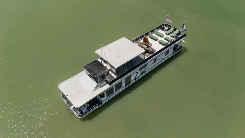 Slide: The Image of Aerial view of 2007 American Waterways Widebody boat on calm green water. - 10