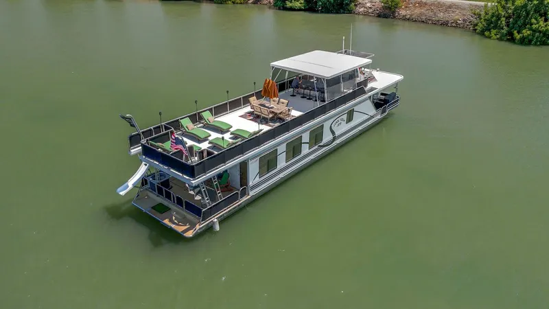 Slide: The Image of Houseboat on calm water, American Waterways Widebody 2007, featuring upper deck seating and slide. - 12