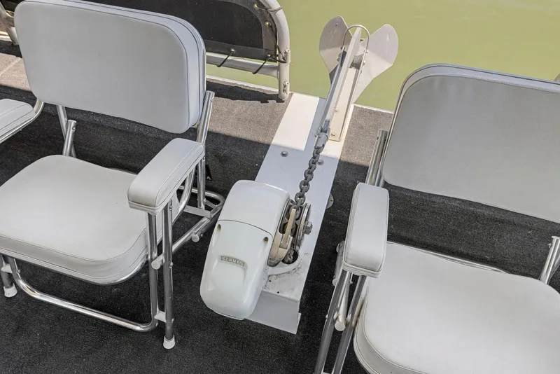 Slide: The Image of Two white chairs on a 2007 American Waterways Widebody boat deck. - 19