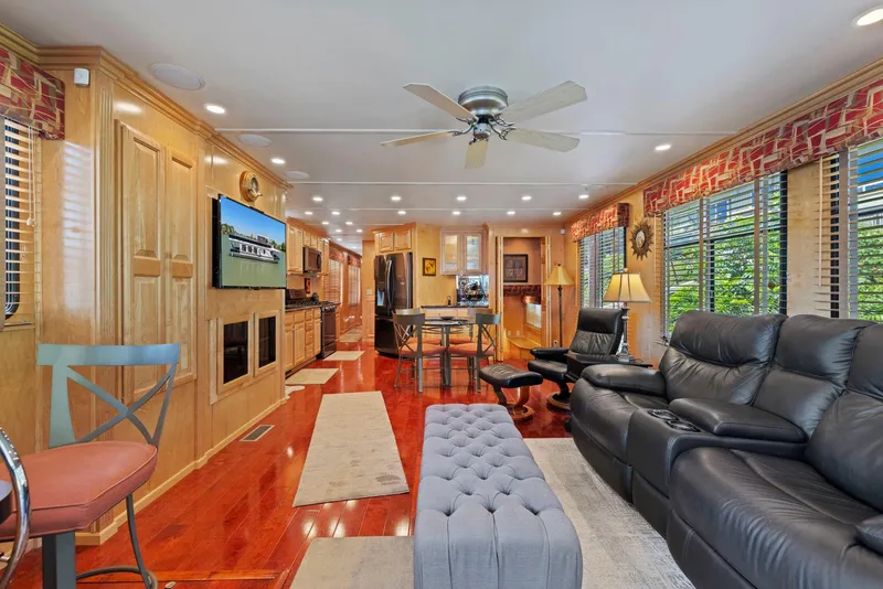 Slide: The Image of Luxurious 2007 American Waterways Widebody interior with leather seating, wood paneling, and modern amenities. - 22