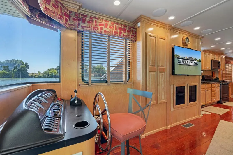 Slide: The Image of Interior of 2007 American Waterways Widebody houseboat with helm, kitchen, and scenic window view. - 23
