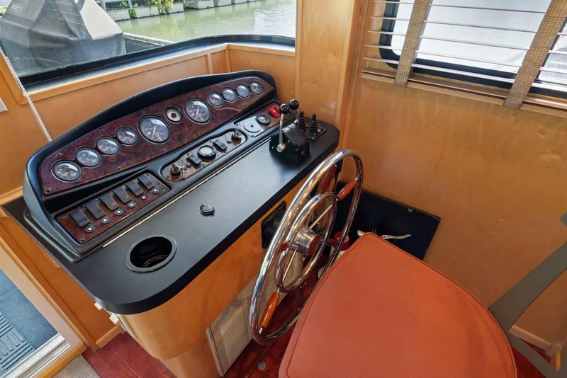 Slide: The Image of Pilot area of a 2007 American Waterways Widebody boat with control panel and steering wheel. - 24
