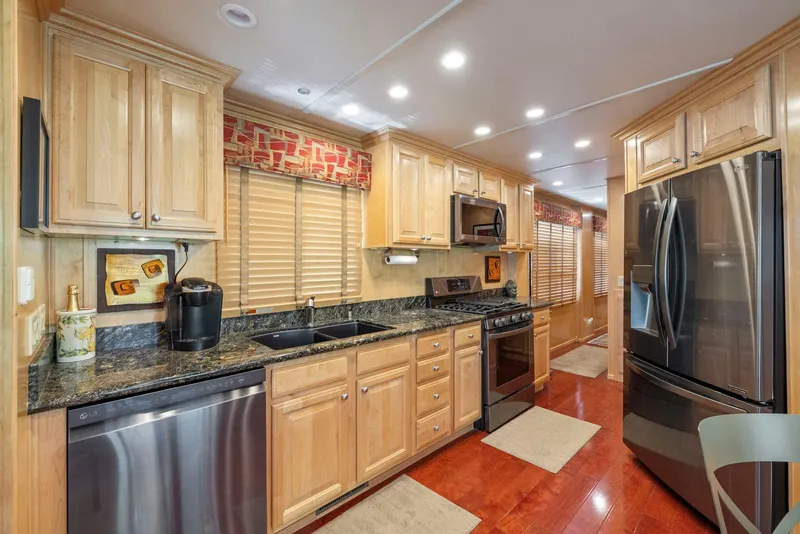 Slide: The Image of Modern kitchen in 2007 American Waterways Widebody, featuring wood cabinets and stainless steel appliances. - 30