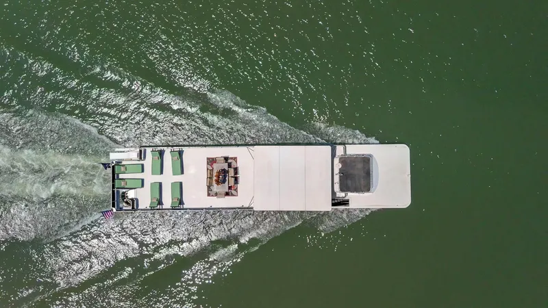 Slide: The Image of Aerial view of 2007 American Waterways Widebody boat cruising on green water. - 32