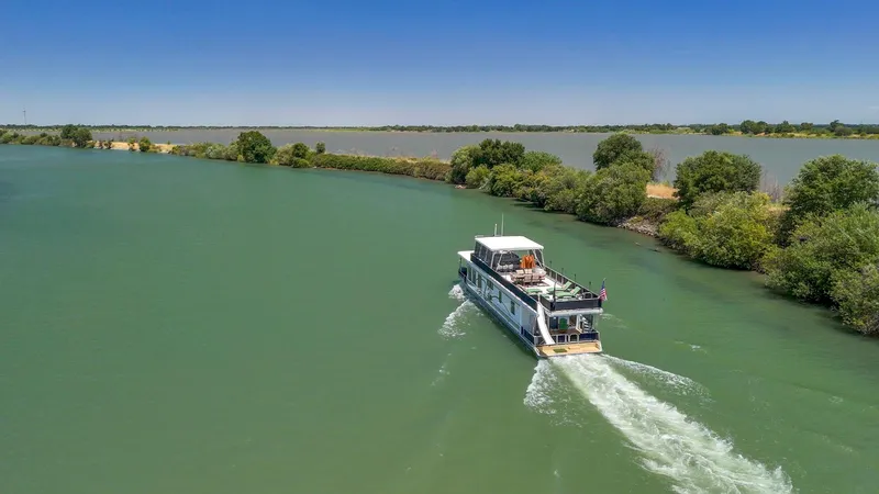 Slide: The Image of A 2007 American Waterways Widebody boat cruising on a scenic river. - 35
