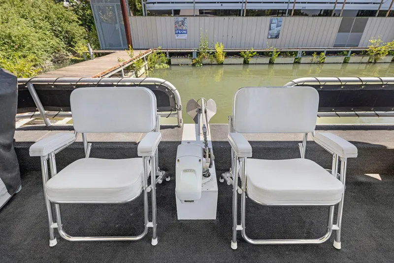 Slide: The Image of Two white chairs on a 2007 American Waterways Widebody boat deck. - 38