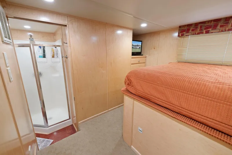 Slide: The Image of Bedroom interior of 2007 American Waterways Widebody with shower, bed, and TV. - 40