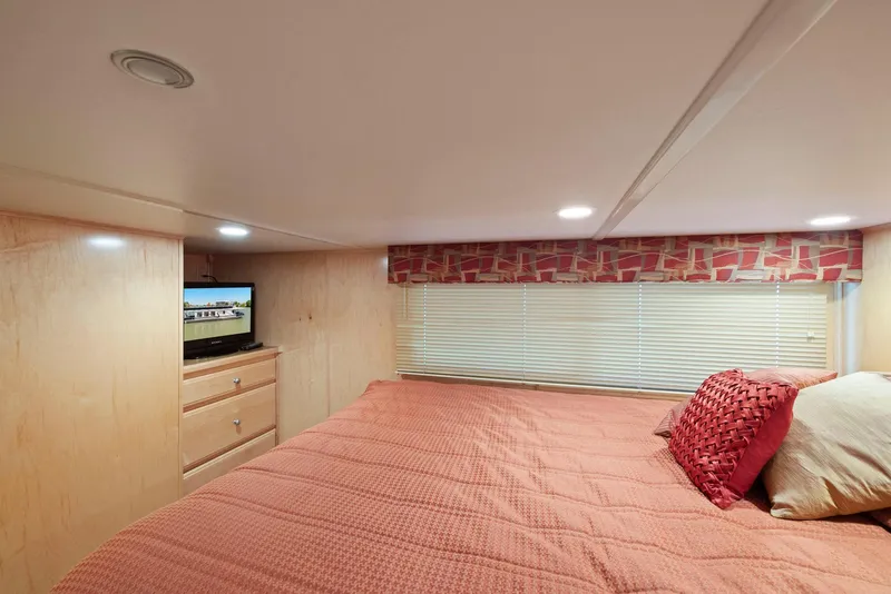 Slide: The Image of Cozy bedroom in 2007 American Waterways Widebody, featuring a TV and stylish decor. - 41
