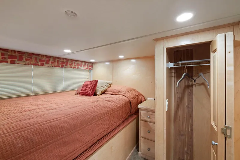 Slide: The Image of Cozy bedroom in 2007 American Waterways Widebody, featuring a bed, closet, and warm lighting. - 42