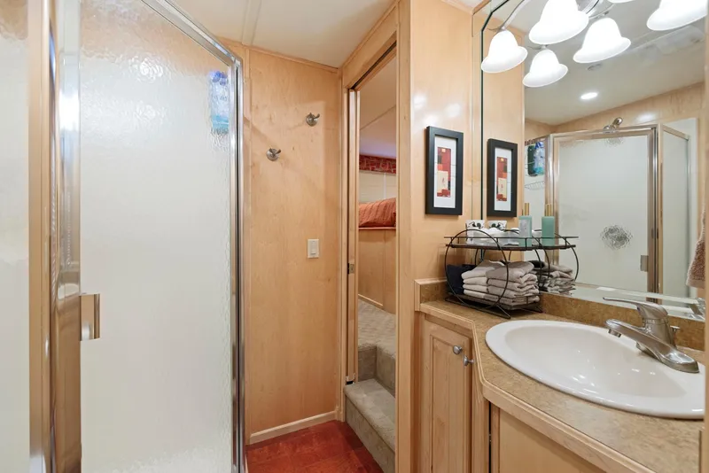 Slide: The Image of Bathroom interior of 2007 American Waterways Widebody, featuring shower and sink area. - 44