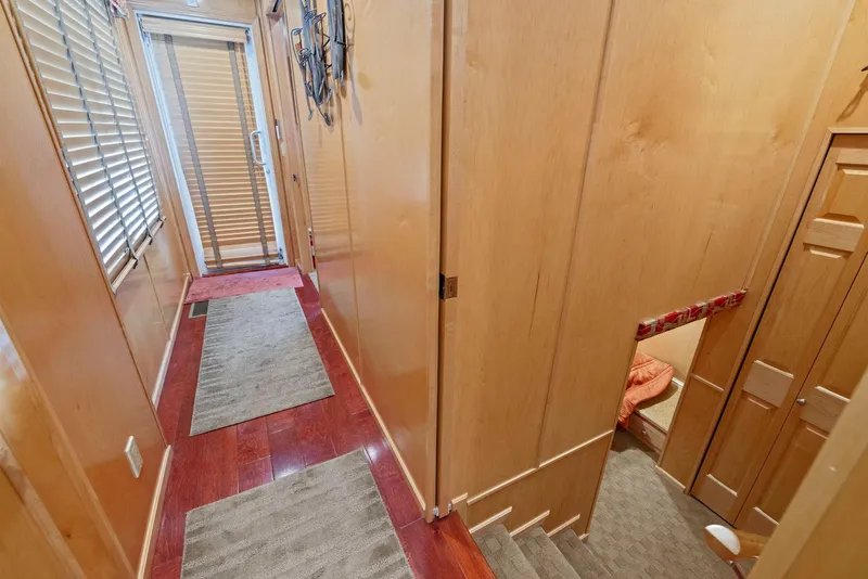Slide: The Image of Narrow hallway in 2007 American Waterways Widebody boat with wooden walls and carpeted floors. - 48
