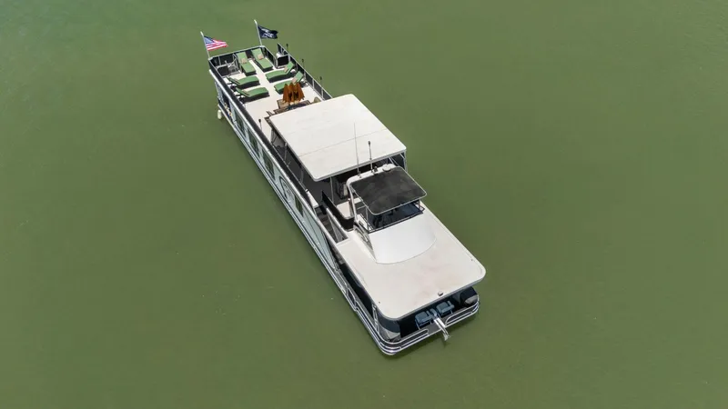 Slide: The Image of 2007 American Waterways Widebody boat on calm green water, aerial view. - 8