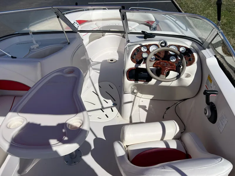 Slide: The Image of Interior of a 2006 Tahoe 204 WT boat with steering wheel and seating. - 14