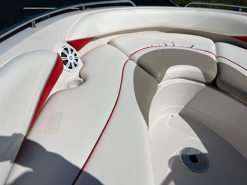 Slide: The Image of 2006 Tahoe 204 WT boat interior with white and red seating, speaker, and cup holder. - 21