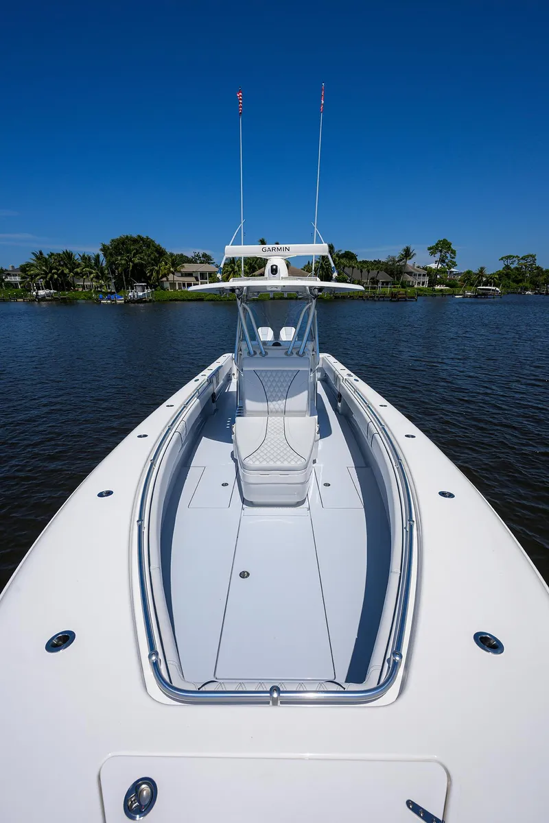 Slide: The Image of 2025 Contender 35 ST boat on calm water under clear blue sky. - 14