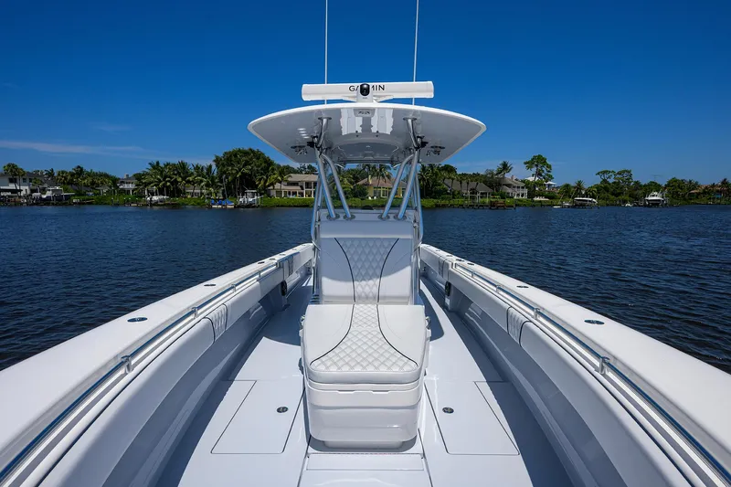 Slide: The Image of 2025 Contender 35 ST boat on calm water, featuring sleek design and spacious seating. - 15