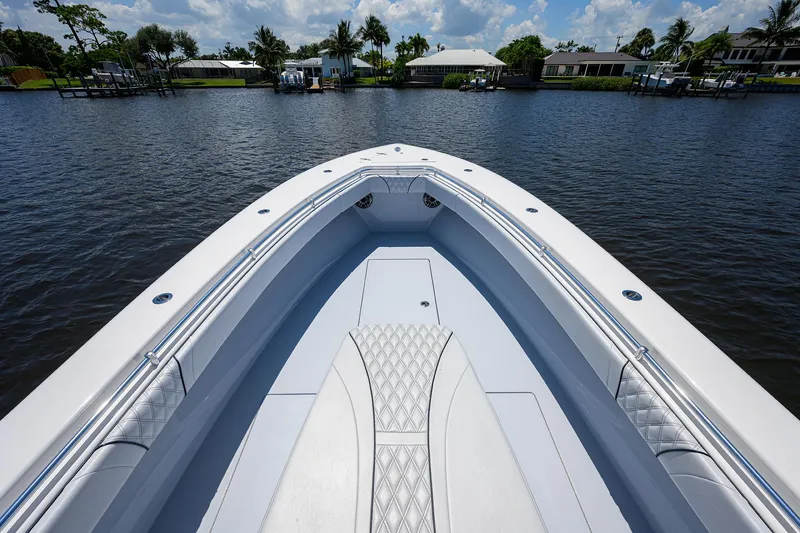 Slide: The Image of 2025 Contender 35 ST boat on calm water, showcasing sleek design and spacious deck. - 17