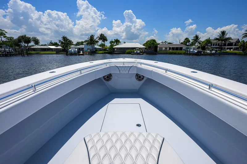 Slide: The Image of 2025 Contender 35 ST boat on calm water under a bright blue sky. - 18