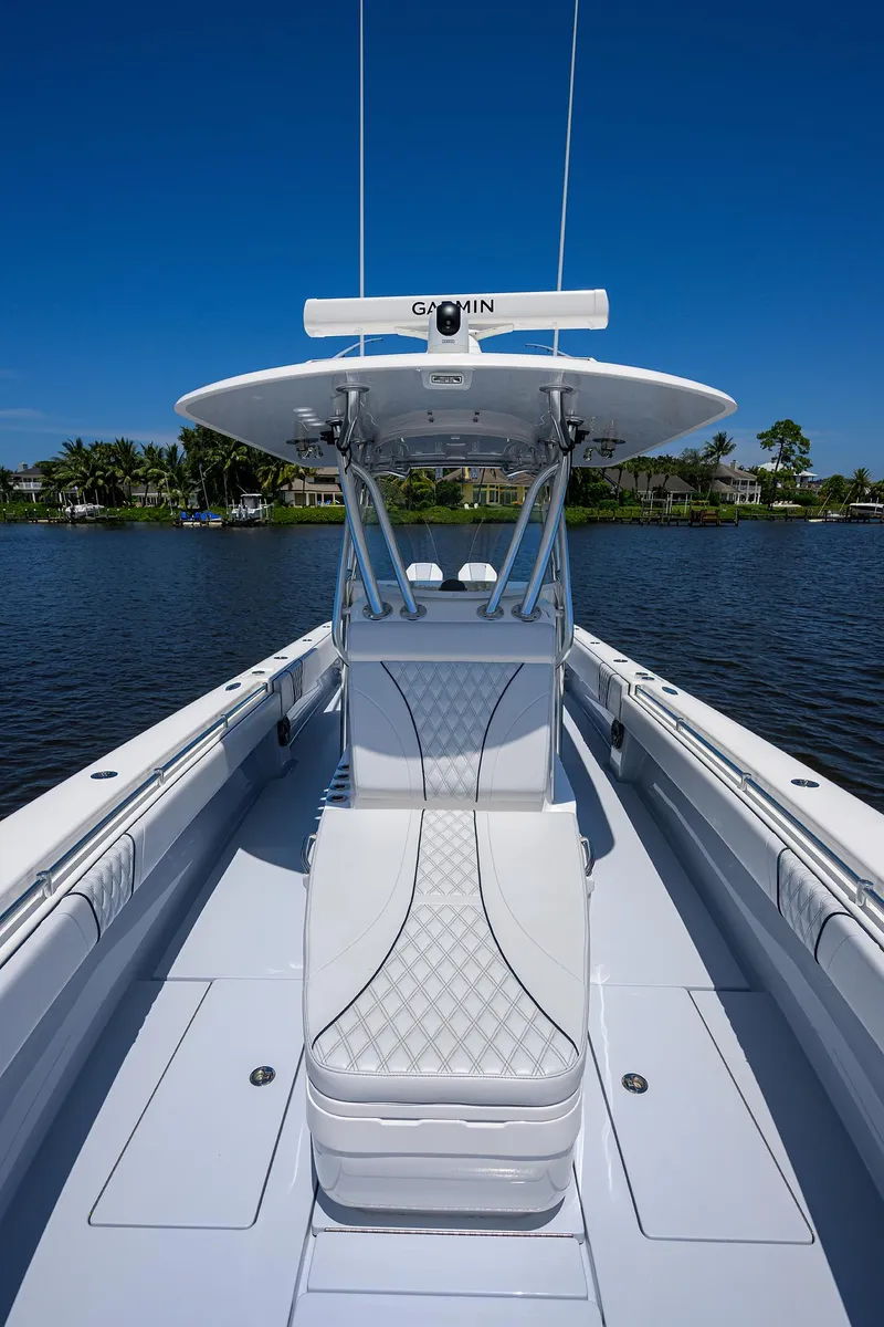 Slide: The Image of 2025 Contender 35 ST boat with sleek white seating and advanced Garmin navigation. - 20