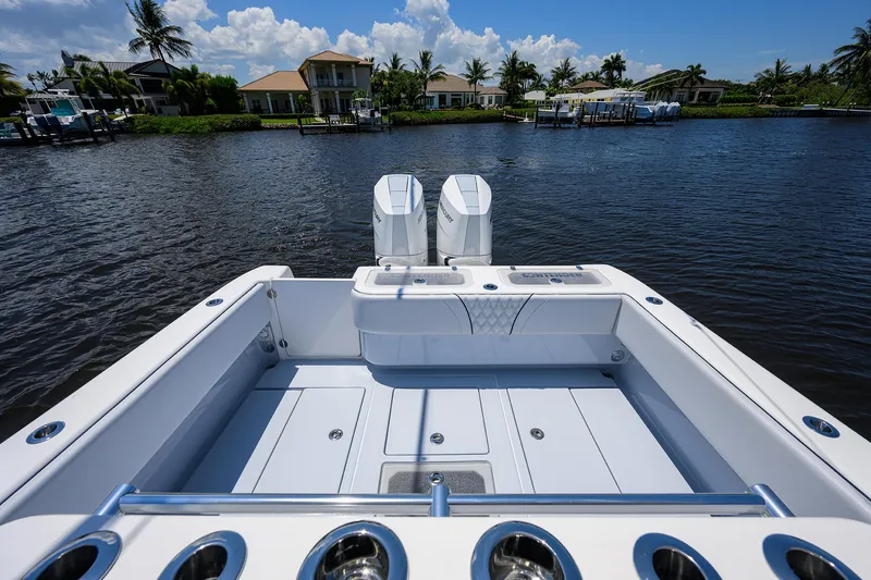 Slide: The Image of 2025 Contender 35 ST boat on water, showcasing spacious deck and dual engines. - 21