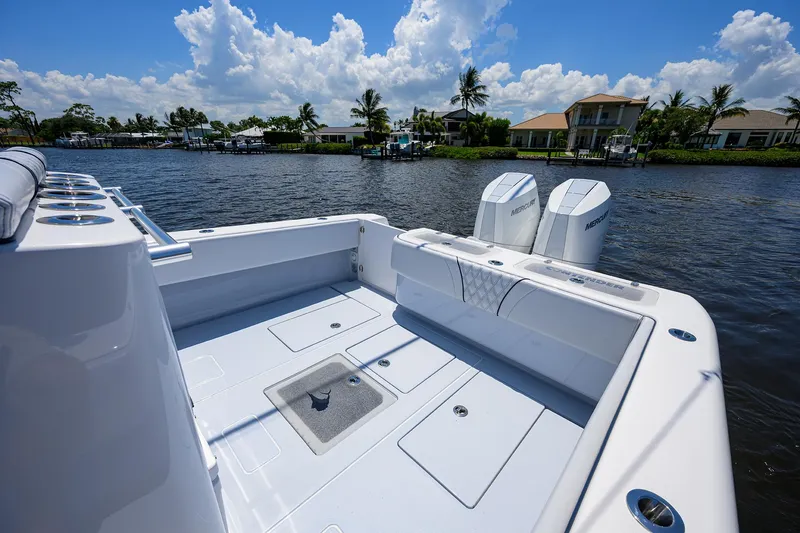 Slide: The Image of 2025 Contender 35 ST boat with dual Mercury engines on a sunny waterfront. - 22