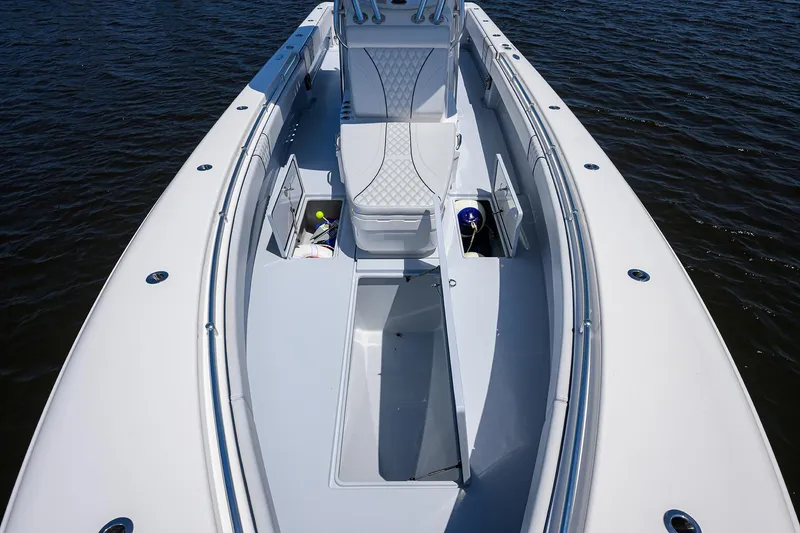 Slide: The Image of 2025 Contender 35 ST boat interior with storage compartments and seating on water. - 23