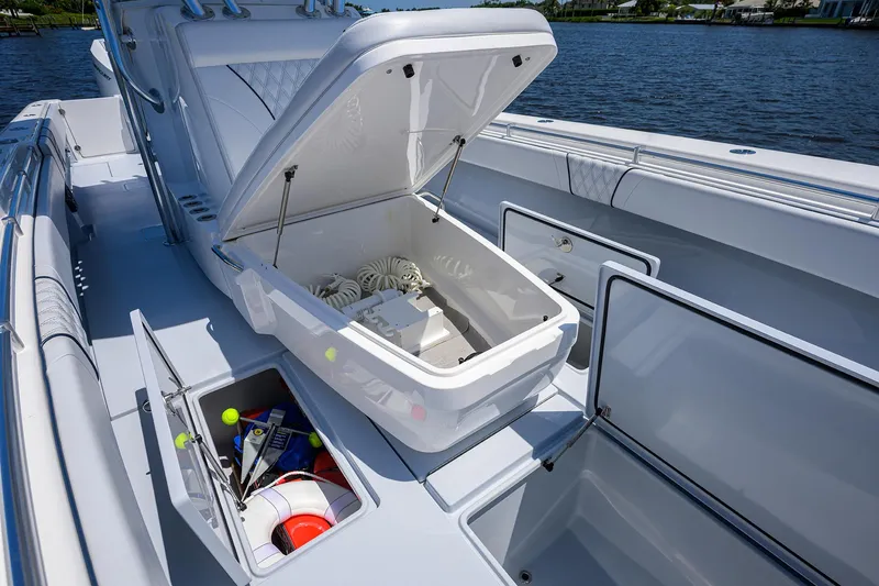 Slide: The Image of 2025 Contender 35 ST boat with open storage compartments on deck. - 24