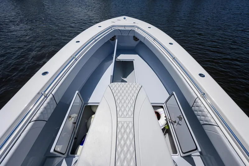 Slide: The Image of 2025 Contender 35 ST boat interior with open storage compartments on calm water. - 26