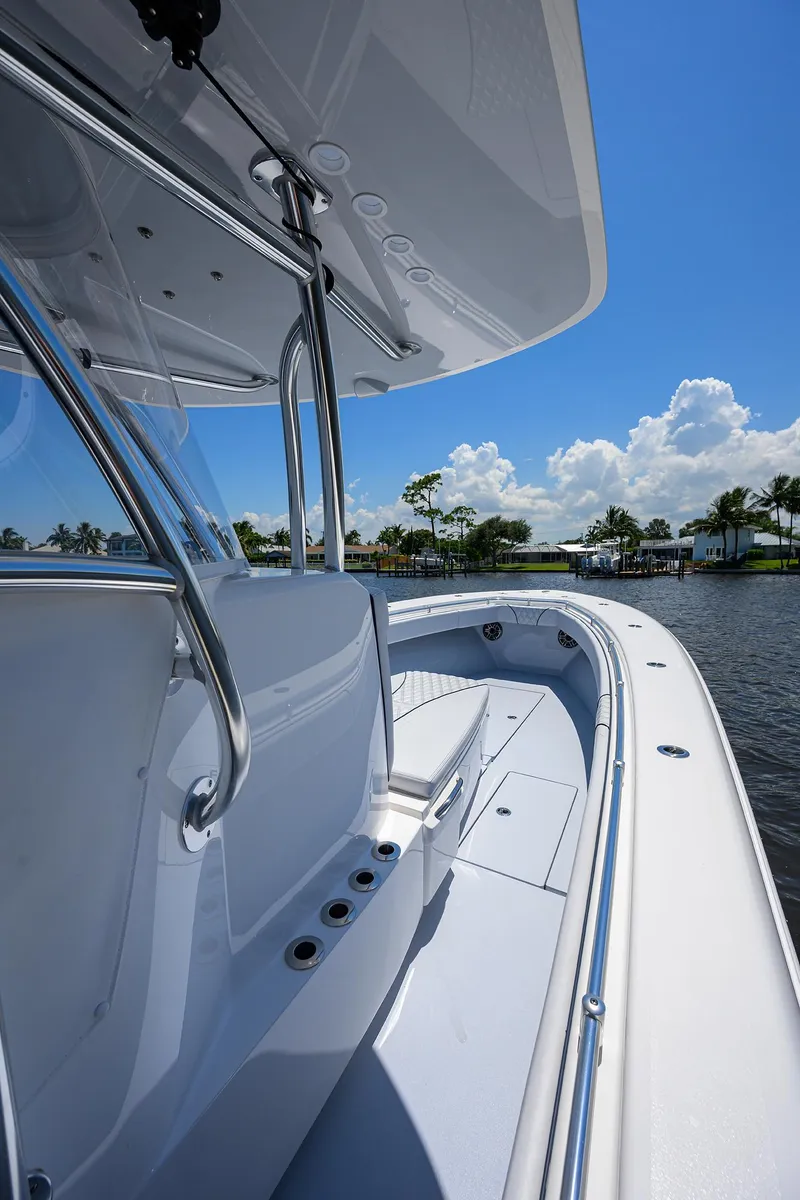 Slide: The Image of 2025 Contender 35 ST boat on a sunny day, showcasing sleek design and spacious deck. - 31