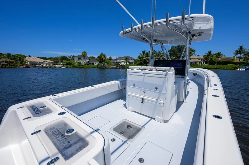 Slide: The Image of 2025 Contender 35 ST boat on calm water, showcasing sleek design and spacious deck. - 34